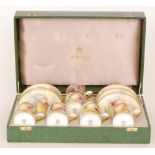 A later 20th Century boxed Minton set of six coffee cans and saucers each decorated in the Fallen