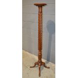 A 19th Century mahogany spiral pedestal torchere on four splayed legs,