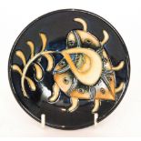 A Moorcroft Pottery Collectors Club pin dish coaster decorated in the Vintage Plume pattern