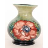 A small Moorcroft vase of globe and shaft form decorated in the Anemone pattern against a blue