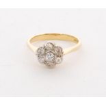 An 18ct diamond daisy cluster ring, collar set brilliant cut diamond within a six diamond surround,