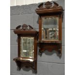 A pair of early 20th Century mahogany framed bevelled edged rectangular wall mirrors,