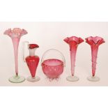 A group of late 19th Century Cranberry glass comprising a pair of trumpet vases each with wave edge