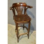 A 1920s stained beech bentwood high back elbow chair, on splayed legs.