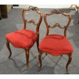 A set of four William IV mahogany dining chairs, the undulating shaped backs with carved splat,