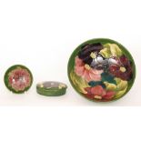 Three pieces of Moorcroft Pottery decorated in the Clematis pattern comprising a large footed bowl,