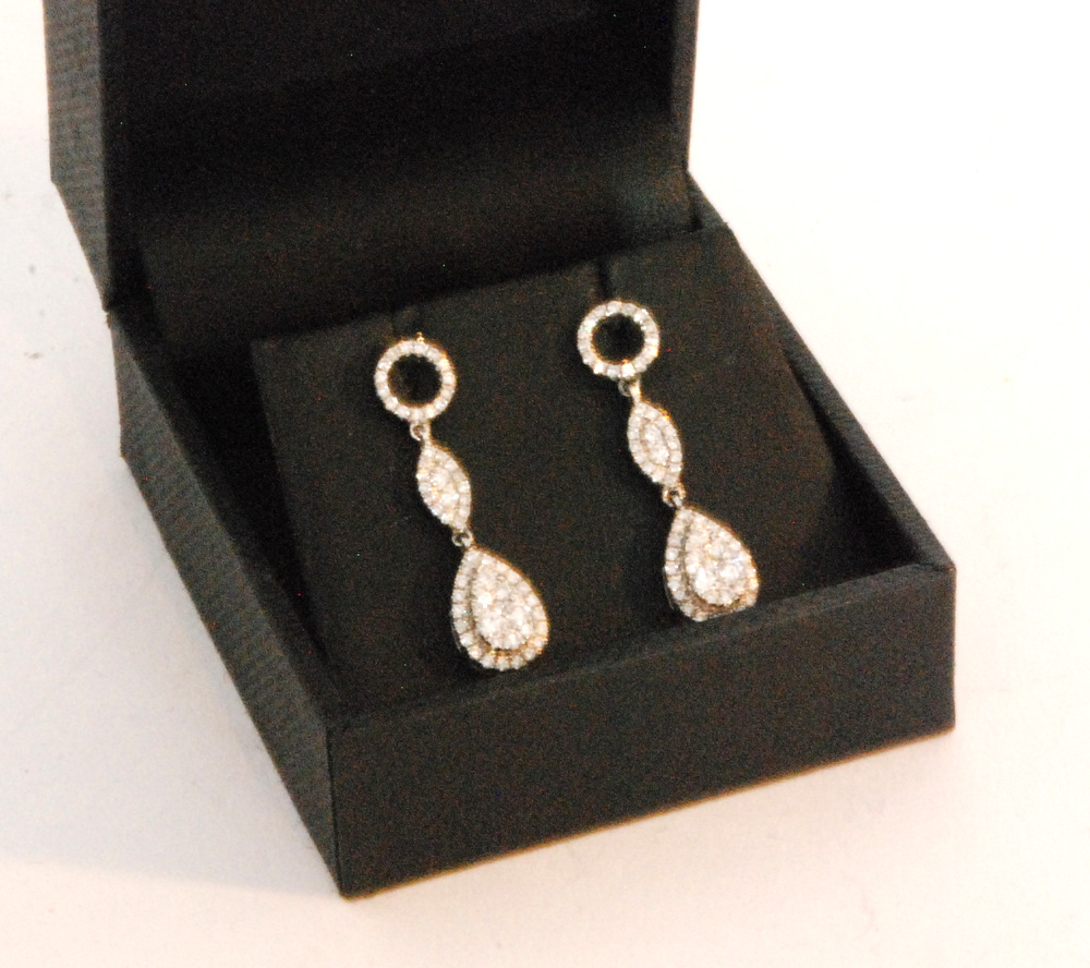 A pair of 18ct white gold diamond pendant earrings,