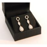A pair of 18ct white gold diamond pendant earrings,