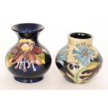 Two small Moorcroft vases, the first decorated in the Columbine pattern,