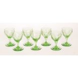 A set of seven 19th Century uranium green wine glasses,