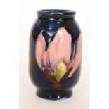 A miniature Moorcroft Pottery vase of barrel form decorated in the Magnolia pattern with two