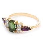 A modern 18ct hallmarked green tourmaline, diamond and amethyst seven stone ring,
