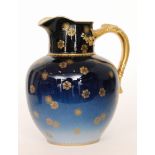 An early 20th Century Haviland & Co Limoges jug decorated in a tonal blue with a gilt applied