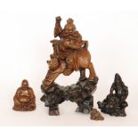 Three early 20th Century Oriental carved hardwood figures to include a tiger with a rider on its