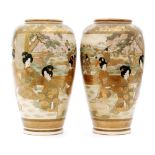 A pair of late 19th Century Japanese Satsuma vases each decorated in the round with a scene of