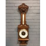 A late 19th Century carved oak barometer by F.