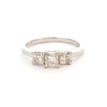 A contemporary platinum diamond three stone ring, princess cut claw set stones,