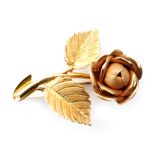 An 18ct hallmarked brooch modelled as a matt finish single flower head to a double leaf stem with