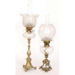 A Victorian brass oil with ribbed floral shade baluster brass column on scroll base, height 51cm,