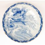 A large late 19th Century Japanese export charger decorated in blue and white with a dragon rising