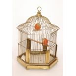 A 20th Century hexagonal bird cage of pagoda form with wire sides, on brass feet, height 50cm.