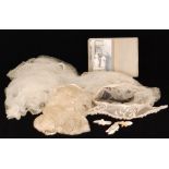 A 1920s vintage wedding veil in the Tudor style with a cream head piece and long chiffon train,