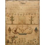An early 19th Century needlework sampler with embroidered religious verse to the top with a
