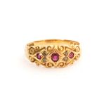 An early 20th Century 18ct hallmarked boat shaped seven stone ruby and diamond ring with scroll