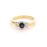 A modern 18ct sapphire and diamond three stone,