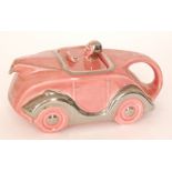 A 1930s Sadler teapot modelled as a pink racing car with silver lustre trims,