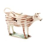 An early 19th Century Staffordshire creamware cow creamer and cover with streaked brown Whieldon