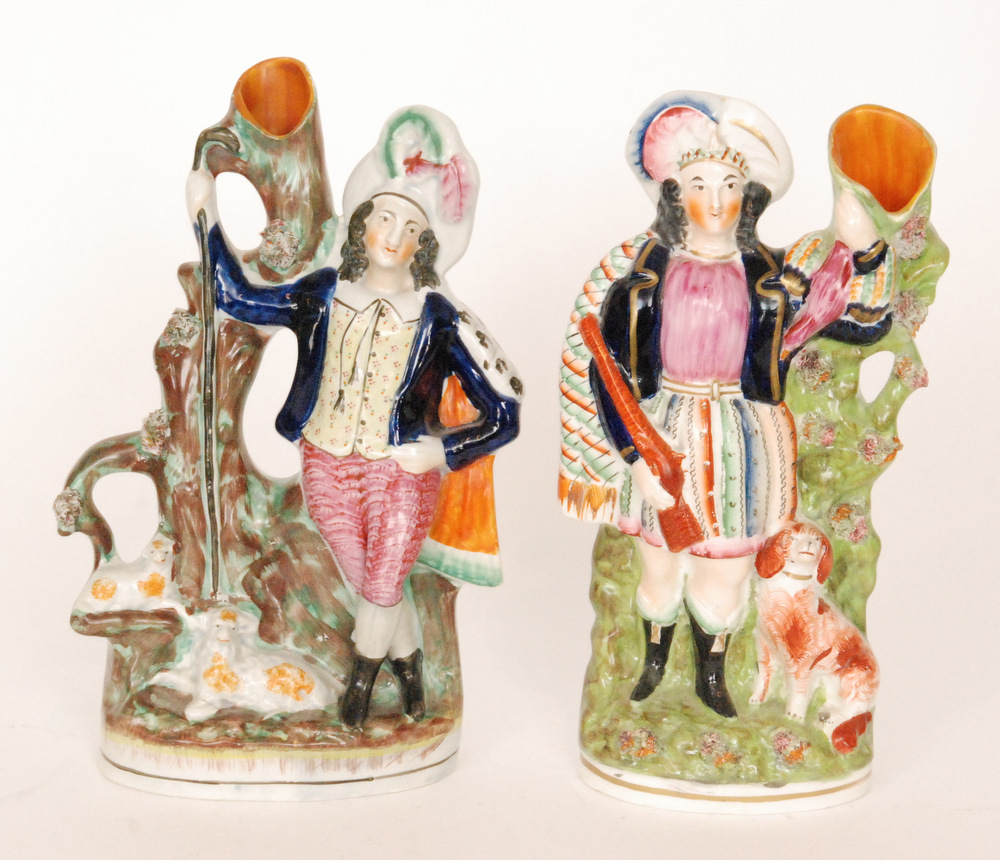 A pair of 19th Century Staffordshire flatback spill vases both with figures in Scottish dress,