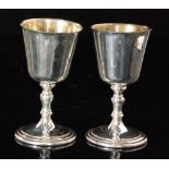 A pair of hallmarked silver goblets each with gilt washed bowl above knopped stem and circular foot,
