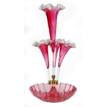 A late 19th Century Stourbridge ruby glass epergne with a deep frill rim bowl rising to a tall