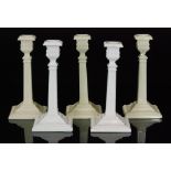 A group of three late 19th Century Sowerby Queens Ivory pressed glass candlesticks of Corinthian