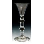 An 18th Century baluster drinking glass circa 1725,