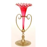 A late 19th Century Stourbridge ruby glass epergne with a deep frill rim bowl rising to a tall