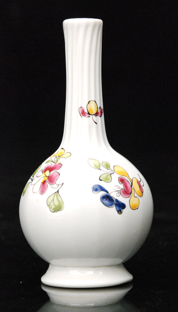 An 18th Century opaque white glass vase circa 1770 of footed globe and shaft form with coloured