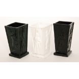 A group of three Sowerby pressed glass vases of footed square form each with a Walter Crane design