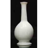 An 18th Century opaque white glass vase circa 1770 of footed globe and shaft form with fluted