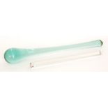 A large 19th Century glass pestle in bottle green, length 57cm,