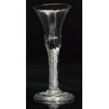 An 18th Century drinking glass circa 1750, the bell bowl above a multi series air twist stem,