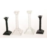 A pair of late 19th Century Sowerby black pressed glass candlesticks,