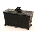 A late 19th Century black pressed two compartment tea caddy in the Aesthetic taste,