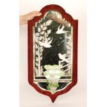 A large late 19th Century Stourbridge glass girondal wall mirror of shield shape mounted to red