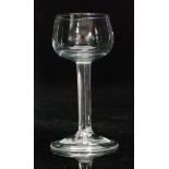 An 18th Century mead glass circa 1740, the cup bowl above a plain stem and conical folded foot,