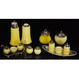 A group of 1920s John Walsh Walsh Primrose glass comprising cruet sets,