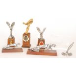 Three Rolls Royce Spirit of Ecstasy mounted trophies each on a wooden plinth, two Jaguar examples,