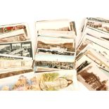 A collection of loose Edwardian postcards to include real photographic cards, street scenes,