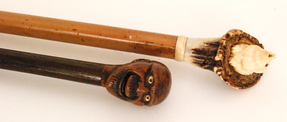 A 19th Century carved horn walking stick with carved antler horn handle in the form of a begging